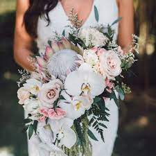 Bouquets can be based on themes like rustic, modern, tropical, or traditional. Bohemian Bridal Dreams A Stunning Bouquet Made Of Protea Orchids Roses And Fresh Gree Tropical Wedding Bouquets White Orchid Bouquet Orchid Bouquet Wedding