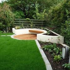 Build some free areas near the water as opposed to having it all filled in with water. This Contemporary Garden Combines A Sunken Seating Area With Rendered Walls And Modern Des Garden Seating Area Sloped Garden Backyard Landscaping Designs