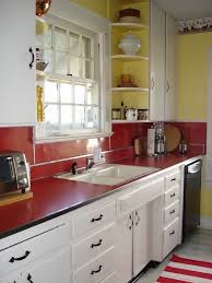 All units feature milling cut panels, turned twisted insets along edges. Red Kitchen Accents Vintage 1950s Red Laminate Counter And Backsplash In An Original Kitchen Via Atticmag Red Kitchen Accents Retro Kitchen Kitchen Design