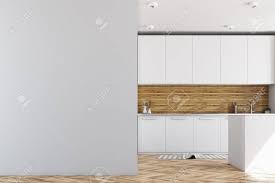 Instead of hanging wall art, lean a few large art prints and mix in small objects and tiny plants on the shelves to create visual interest while showing off your personal style. Luxury Kitchen Interior With White And Wooden Walls A Wooden Floor White Countertops And A Blank Wall Fragment 3d Rendering Mock Up Stock Photo Picture And Royalty Free Image Image 98027113