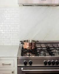 A Two Toned Backsplash Includes A White Marble Slab And White X2f Gray Subway Tile That Seeming Kitchen Backsplash Designs Transitional Kitchen Kitchen Marble