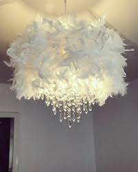 Perfect for your living room or bedroom, this chandelier has an elegant, versatile design with crystals on it. White Feather Chandelier Shade Handmade Home Decor Fluffy Baby Nursery Home Furniture Diy Lighting Lampsh Diy Chandelier Feather Chandelier Feather Lamp