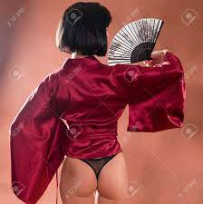 Sexy Geisha In Japanese Red Kimono With A Fan. Back View Female Ass In  Black Panties Stock Photo, Picture and Royalty Free Image. Image 91550898.