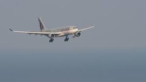 PHUKET, THAILAND - FEBRUARY 22, 2023. Commercial jet Airbus A330 of Qatar  Airways approaching landing at Phuket airport. Background of the sea.  Tourism and travel concept