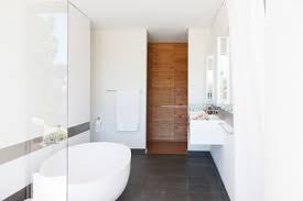 A look inside the glasshaus: Modern Bathroom Interior With Large Bathtub And Wooden Door Stockphoto