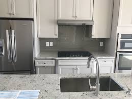 Grey Kitchen Cabinets With Glass Subway Tile Backsplash And Bianco Romano Granite Counters With Images Kitchen Cabinets Grey Kitchen Cabinets Minimalist Kitchen Design