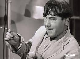 Moe is almost deranged as he tries to catch the fish in Curly's stomach.