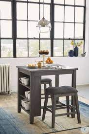 Dine in chic, contemporary style with this elegant dining set. Caitbrook Gray 3 Piece Counter Height Dining Room Set From Ashley Coleman Furniture