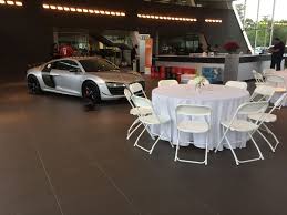 White Hercules Chairs And 60 Round Tables At The Jim Ellis Audi Atlanta Showroom The Audi R8 Doesn Table Linen Rentals Corporate Event Planner Atlanta Party