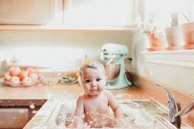 Happy family mother and baby in a blue towel after bathing in the bath. 8 Best Baby Sink Ideas Baby Photography Baby Baby Photos
