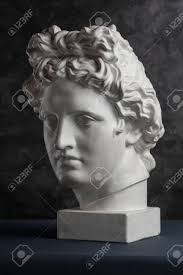 Gypsum Copy Of Ancient Statue Apollo Head On Dark Textured Background.  Plaster Sculpture Man Face. Stock Photo, Picture and Royalty Free Image.  Image 128908785.