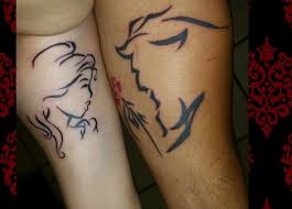 The woman's tattoo is in pink and decorated with a bow while the man's tattoo is. Beauty And The Beast Unique Couple Tattoos Best Tattoo Ideas