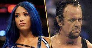 The photo features banks taking on a look inspired by undertaker's american badass days, complete with a neck tattoo that spells out bayley, making. Wwe Undertaker 30th Anniversary Photoshoot Reveals Bayley Tattooed Sasha Banks