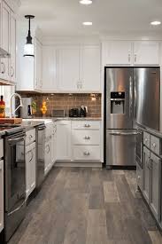 Bertch marketplace cabinetry with the visage door fills this kitchen with warmth. Bertch Cabinets Perimeter Is Marketplace Featuring The Cambridge Door Style In White And The Island Bertch Cabinets White Kitchen Remodeling Kitchen Remodel