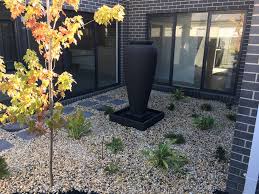 A concrete paver walkway with mexican pebble joints leads from the main house to the backyard art studio. Earthtech Landscape Solutions