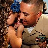 Executive Officer, Cmdr. Stephen Koehler, 2nd left, and Fleet Honoree crew  members assigned to the Nimitz-class aircraft carrier USS Carl Vinson (CVN  70) pause before the opening ceremonies of the NASCAR Nationwide