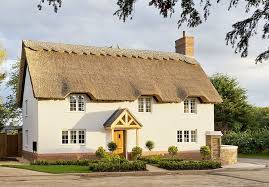 A thatched roof gives a natural charm to a house; Water Reed Heart Of England Master Thatchers