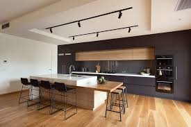 Stray from the straight and narrow like this sleek black kitchen island with seductive curves. Modern Bar Stools Kitchen Modern With Timber Island Bench Modern Bar Stool Contemporary Kitchen Design Modern Kitchen Island Modern Kitchen Design