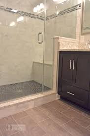 This Warm Transitional Bathroom Design In A Walden Garage Townhome In Crofton Combines A Frameless Trendy Bathroom Tiles Stone Shower Floor Best Bathroom Tiles