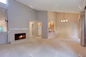 Living room beige floor tiles what paint color. Empty Living Space With Vaulted Ceiling Grey Walls Paint Color And Carpet Floor Cozy Wood Burning Fireplace With Beige Tile Surround Northwest Usa Stock Photo Picture And Royalty Free Image Image 94710856