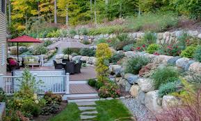 Composite Deck And Beautifully Planted Terraces Landscape Design Retreat Boulder Retaining Wall