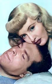 Fred MacMurray and Barbara Stanwyck sharing a laugh