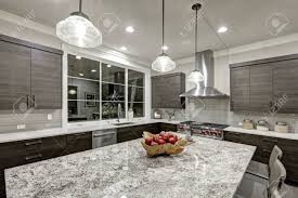 Maybe you would like to learn more about one of these? Modern Traditional Kitchen Design In New Luxury Home Features Dark Gray Cabinets White Quartz And Granite Countertops Glossy Gray Linear Tile Backsplash And Large Kitchen Island Northwest Usa Stock Photo Picture And