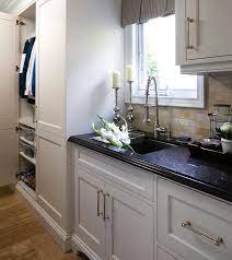 Weathered nickel and brass finishes are growing in popularity. Gorgeous Mudroom With White Shaker Fronted Cabinets And Polished Nickel Hardware Antique White Kitchen Antique White Kitchen Cabinets Kitchen Cabinet Hardware