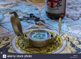 Old World Map With Charting Tools Compass And Beer Bottle