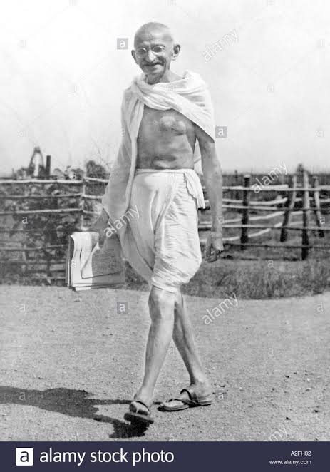 Mahatma Gandhi wearing dhoti with papers in hand walking at Sevagram Ashram Wardha Nagpur India 1936 old vintage 1900s picture Stock Photo - Alamy