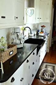 The addition of small open shelves beside the sink is both stylistic and a great choice for providing extra storage space in a small kitchen. 12 White Kitchen Cabinets Black Hinges And Hardware Ideas White Kitchen Cabinets White Kitchen Kitchen Remodel