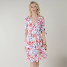 Concealed zipper at one side, short puff sleeves, and elasticized cuffs with ruffle trim. Floral Print Dress With V Neck And Short Sleeves Pink Print On White Background Molly Bracken La Redoute