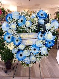 For such occasions relatives usually order various ritual flowers, such as mourning flowers, funeral wreaths, and casket sprays for decorating the coffin. Blue White Large Heart Funeral Tribute By Petals Warwick In Ri Funeral Floral Arrangements Funeral Floral Funeral Flower Arrangements