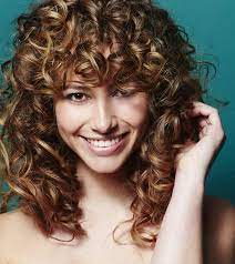 Magnificent side bangs and a side part can upgrade a short, naturally curly hairstyle. 20 Most Incredible Curly Hairstyles With Bangs