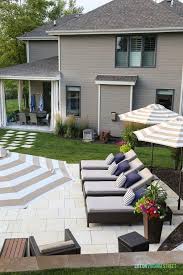 Gorgeous Oasis Shaped Vinyl Pool Striped Umbrellas Striped Outdoor Curtains Checkerboard Pathway Concrete Travertin Backyard Pool Outdoor Patio Decor Patio