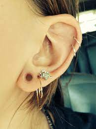my left ear 2 helix piercings 4gauge clear tunnels and 3 lobe piercings 3 lobe piercings helix piercing lobe piercing