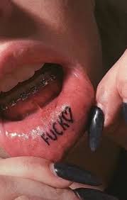 / a kiss like a mouth tattoo / burns in me and i don't know what i'll do / it hurts so good and bad / he's waiting / she's waiting at home / branded by love / it's etched in Lower Lip Tattoo In 2020 Lip Tattoos Inside Lip Tattoos Dainty Tattoos
