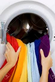 Colored clothes can be washed on cool or warm settings, and both have their benefits. Woman Taking Color Clothes From Washing Machine Housework Stock Photo Picture And Royalty Free Image Image 30213411