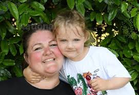 39729355-Suki Cummins gives the best of cuddles to her mum Daraca Lynch in  Ward Jackson Park. Picture by FRANK REID