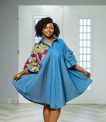 A casual, easy-fitting denim shirt dress with a touch of African print and  a hint of drama on the sleeves. We've thought of everything, and we know  you'll love it! 📍 First