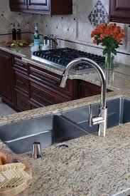 An elegant vintage kitchen tap crafted of solid brass with a slightly aged finish. East Linear Pull Down Kitchen Faucet 1500 5103 Newport Brass