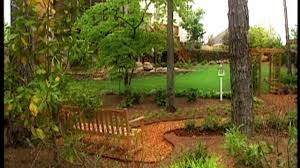 In this backyard landscaping idea, the path itself is defined by the way the homeowner has placed the curving bushes. Backyard Landscaping Ideas Diy