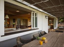 Outdoor kitchens are typically smaller than their indoor counterparts, and insufficient countertop space is still one of the most common design shortcomings i see. Outdoor Kitchen Bar Connected To Inside Kitchen Area Indoor Outdoor Kitchen Outdoor Kitchen Design House Design