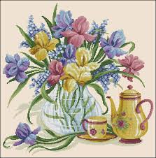 From letter samplers to flowers and birds, our range of free cross stitch and embroidery patterns will have you stitching in no time. Irises In A Vase Free Cross Stitch Pattern Free Cross Stitch Patterns