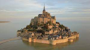 I'll guide you up and down its intricate stairways through hidden doors. Mont Saint Michel Wikipedia