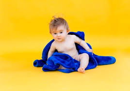 After your baby's umbilical cord stump falls off, you can transition from sponge baths to actual baths in a sink or a baby bathtub. Free Photo Focused Young Mom Holding Sweet Dry Baby Wrapped In Hooded Towel After Shower Playing With Rubber Bathing Toy Front View Copy Space Child Care Or Bathing Concept