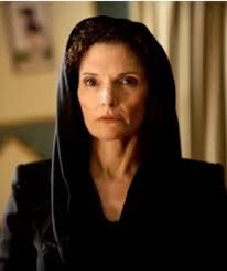 What is the name of the female villain in a kids movie who is a ninja and  has curly hair and spider-like instincts?