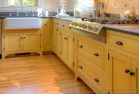 Traditional Yellow Kitchen With A Custom Wood Island Yellow Kitchen Cabinets Kitchen Cabinets Wood Kitchen Cabinets