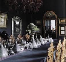 A gothic dining room with light stone walls, a patterned ceiling, a heavy table and chairs, a black chandelier and purple linens. 36 Refined Gothic Kitchen And Dining Room Designs Digsdigs