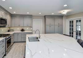 The kitchen features cesarstone countertops with maple cabinets below. Quartz Vs Quartzite Countertops Plus Quartzite Pros Cons Luxury Home Remodeling Sebring Design Build